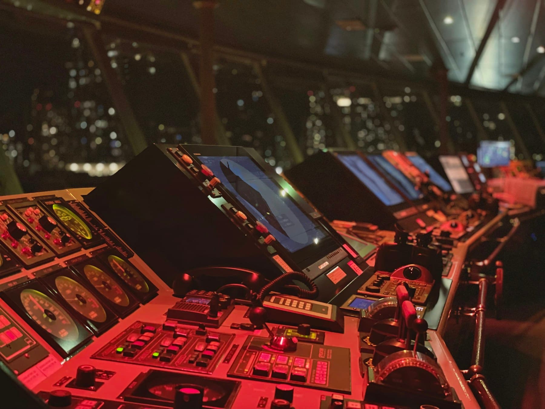 An operations control room with multiple consoles and displays